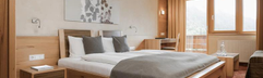 Tweepersoonsbed in appartement met uitzicht op de bergen