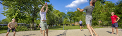 Jongeren spelen volleybal in het zand op het sportveld