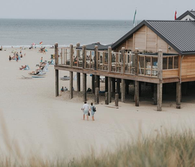 Restaurant op palen aan het strand op de Waddeneilanden met uitzicht op zee