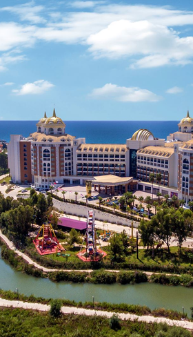 Luchtfoto van het luxe en uitgestrekte Delphin BE GRAND Resort in Lara, Turkije, gelegen aan zee.