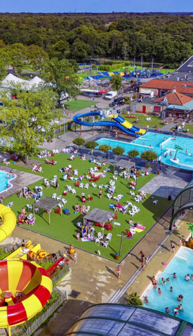 Luchtfoto van het enorme waterpark op Capfun Camping Wondermolen met meerdere zwembaden en spectaculaire glijbanen.
