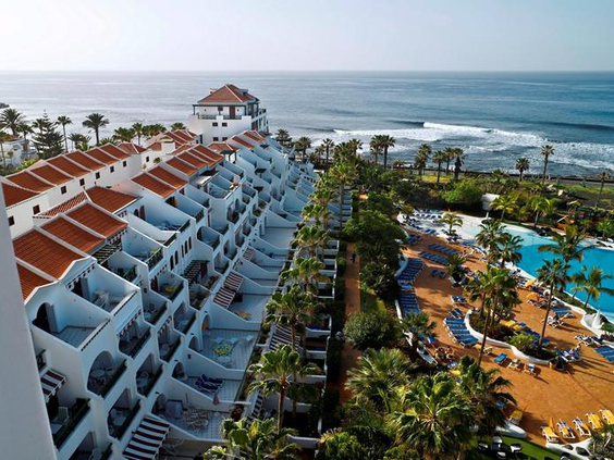 Uitzicht van bovenaf op de appartementen, het grote zwembad en de ligging direct aan de Atlantische Oceaan bij Parque Santiago III op Tenerife.