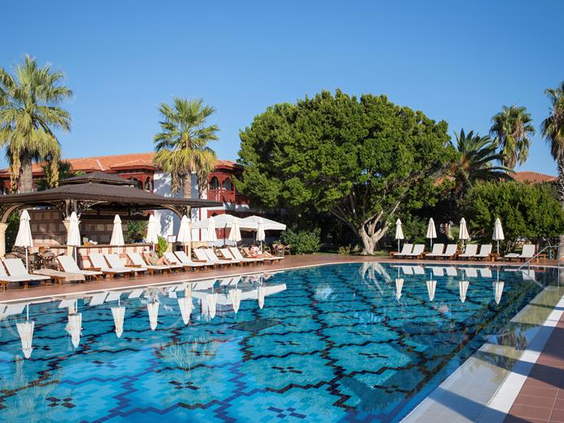 Het rustige 'Silent Pool' zwembad van Hotel Ali Bey Club in Side, Turkije, omringd door ligbedden en groene bomen voor ontspanning.