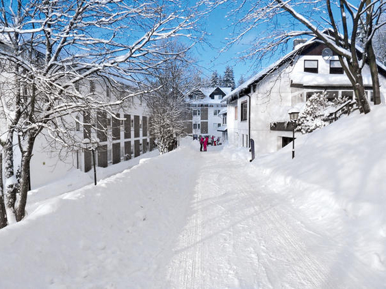 Een diep besneeuwd pad bij Hotel Winterberg Resort, ideaal voor een winterwandeling of slee-avontuur.