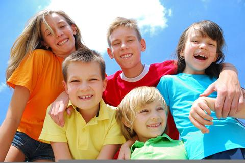 Een groep lachende kinderen en tieners die samen plezier hebben tijdens hun familievakantie in Duitsland.