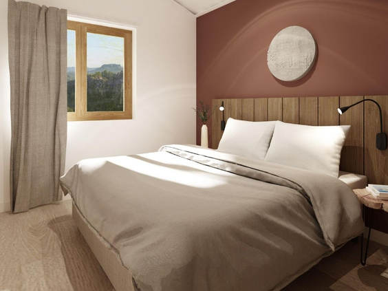 Een comfortabele en moderne slaapkamer in een appartement van Landal Arber met een opgemaakt tweepersoonsbed.