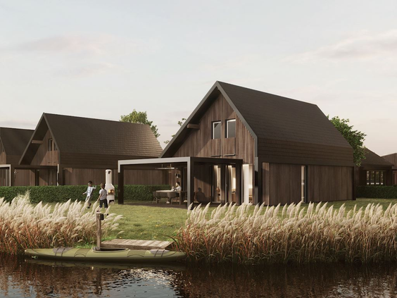 Sfeervolle houten vakantiewoning aan het water op Landal Elfstedenhart in Friesland, omringd door riet en natuur.