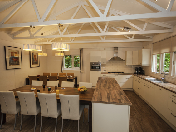 De ruime en moderne open keuken met een lange eettafel in een groepsaccommodatie van Landal Heideheuvel op de Veluwe.