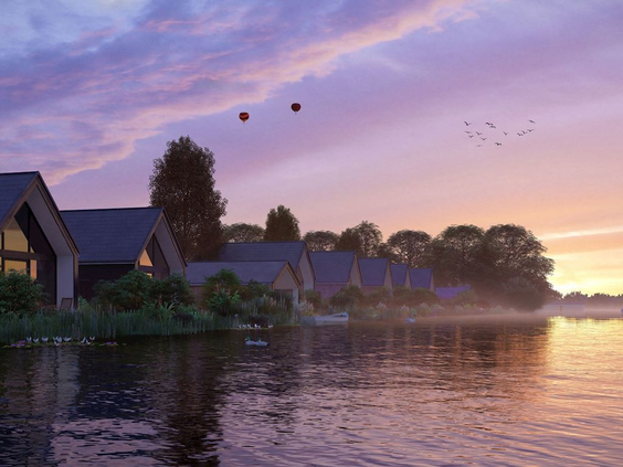 Watervilla's aan het water op Landal Waterresort Blocksyl tijdens een prachtige, kleurrijke zonsondergang.
