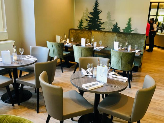 Het sfeervolle en gezellig ingerichte restaurant van het Relexa Hotel in Braunlage, met een muurschildering van een bos.