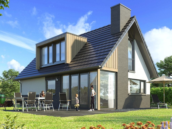 De buitenkant van een luxe, moderne vakantievilla met een groot terras en tuin op Residence Berger Duinen.