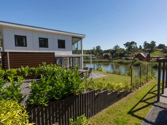Een moderne, luxe watervilla met terras en tuin direct aan het water op Resort Brunssummerheide in Limburg.