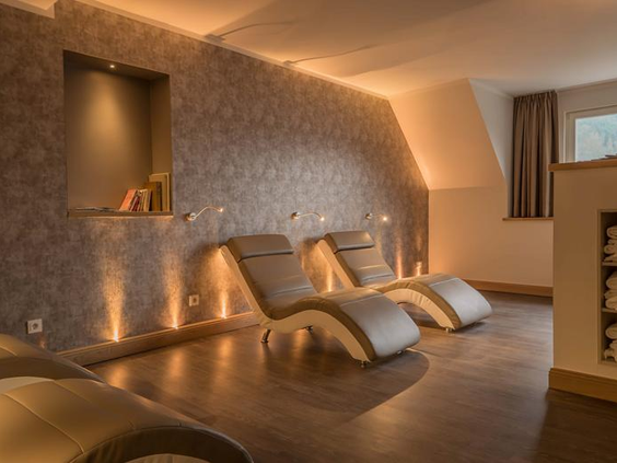 De sfeervolle relaxruimte in de spa van Hotel Bellevue, met comfortabele, verwarmde ligbedden om te ontspannen.