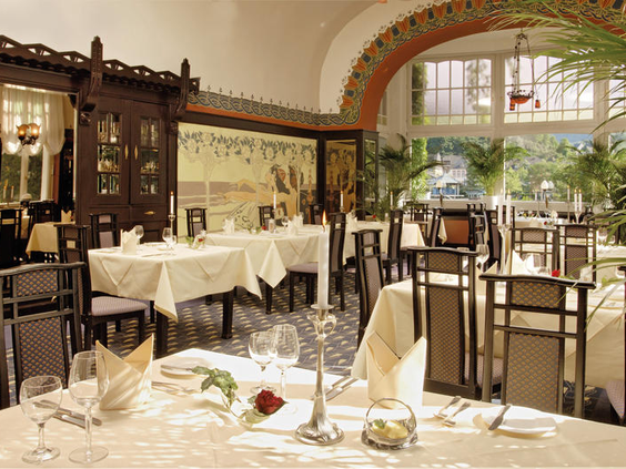 Het klassieke en chique restaurant 'Belle Epoque' van Romantik Jugendstilhotel Bellevue, met stijlvol gedekte tafels.