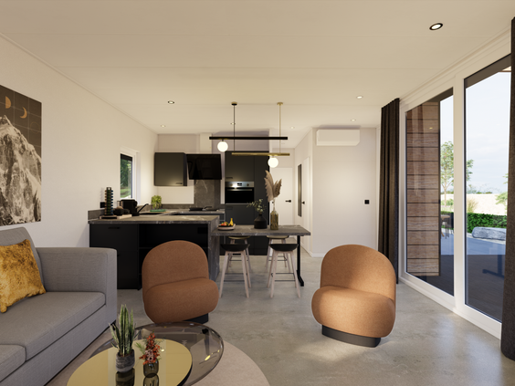 Modern en sfeervol interieur van een luxe chalet op Strandpark De Zeeuwse Kust in Zeeland, met een comfortabele zithoek en open keuken.