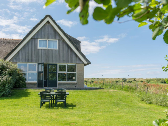 Luxe en vrijstaande vakantiewoning met rieten dak, gelegen in de duinen van Vakantiepark Boomhiemke op Ameland.