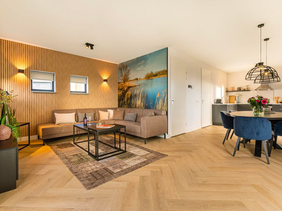 Sfeervolle woonkamer met een comfortabele zithoek in een van de vakantiehuizen op De Strabrechtse Vennen.