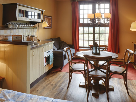 Het comfortabele interieur van een appartement in het Poorthuys of Landhuys van Efteling Bosrijk, met keuken en eethoek.