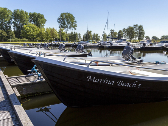 Motorboten van Marina Beach liggen aangemeerd in de jachthaven, klaar om het water op te gaan in Zeeland.
