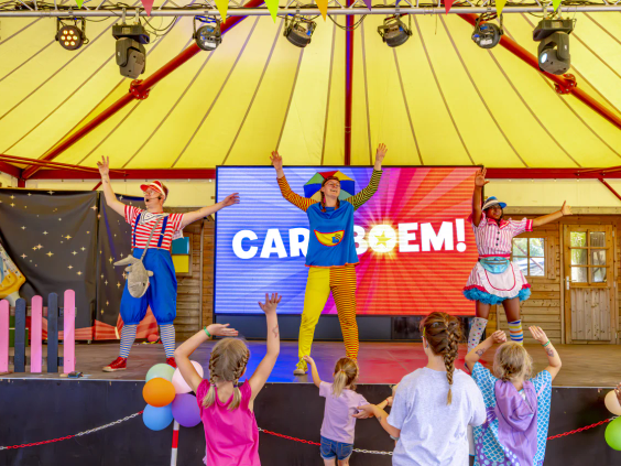 Animatieteam geeft een interactieve show op het podium met het Caraboom logo