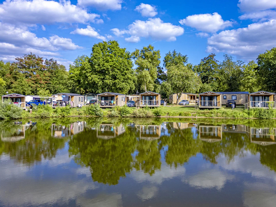 Een rustige vijver omgeven door bomen op vakantiepark Vlinderloo in Overijssel