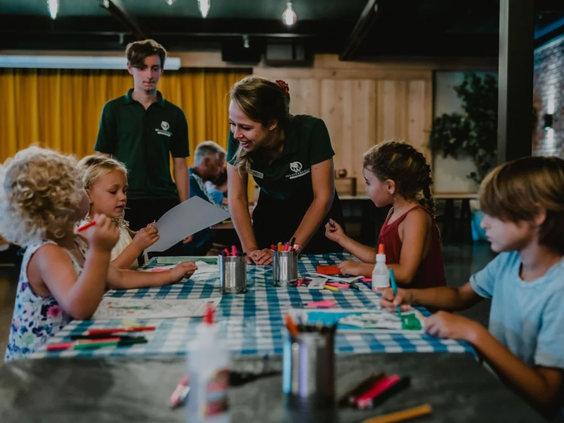 Kinderen zijn creatief bezig met knutselen onder begeleiding van het enthousiaste animatieteam in de kidsclub van Vakantiepark Westerbergen.