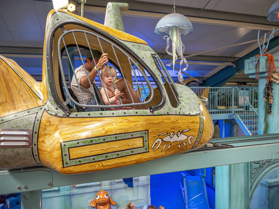 Kinderen spelen in een indoor speeltoestel in de vorm van een vliegtuig