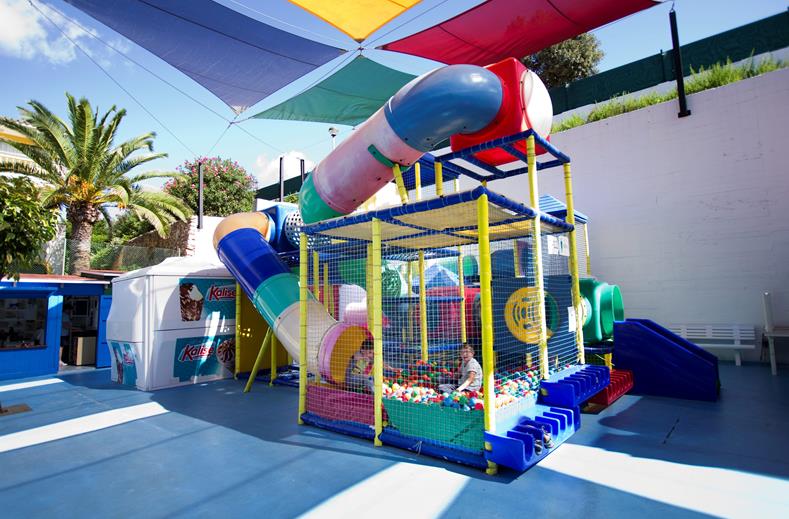Het kleurrijke indoor speelparadijs 'Kikoland' bij Royal Son Bou, compleet met een ballenbak, glijbaan en klimtunnels.