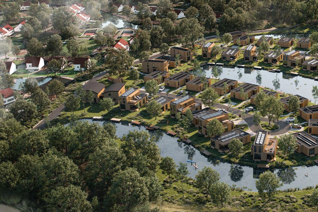 Luchtfoto van vakantiepark Landal De Wedderplassen, met de vakantiehuizen gelegen tussen het groen en aan het water.