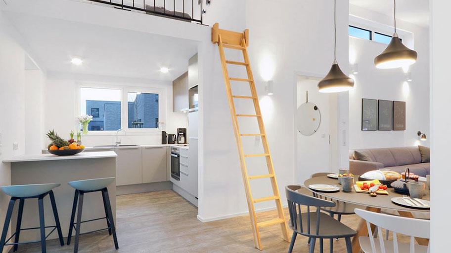 Open keuken en eetgedeelte in moderne vakantiewoning Landal Marissa, met een unieke houten ladder naar een slaapvide.
